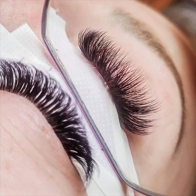 Close-up of eyelash extensions application.