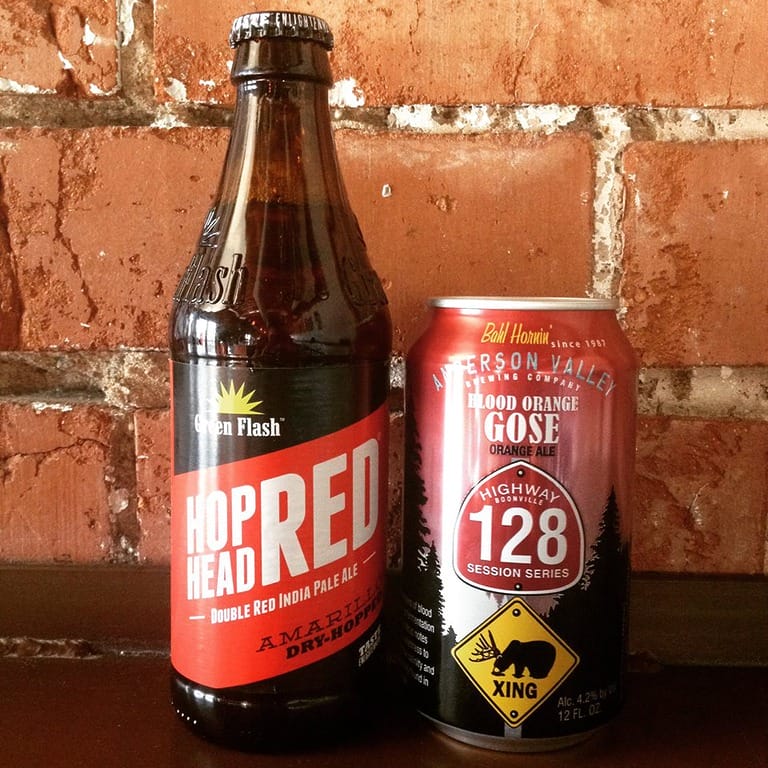 Craft beer bottle and can against brick wall