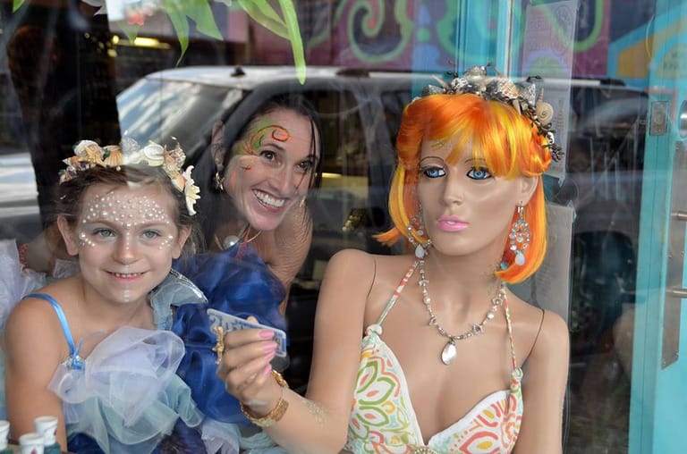 Young girl, woman, and mannequin in window