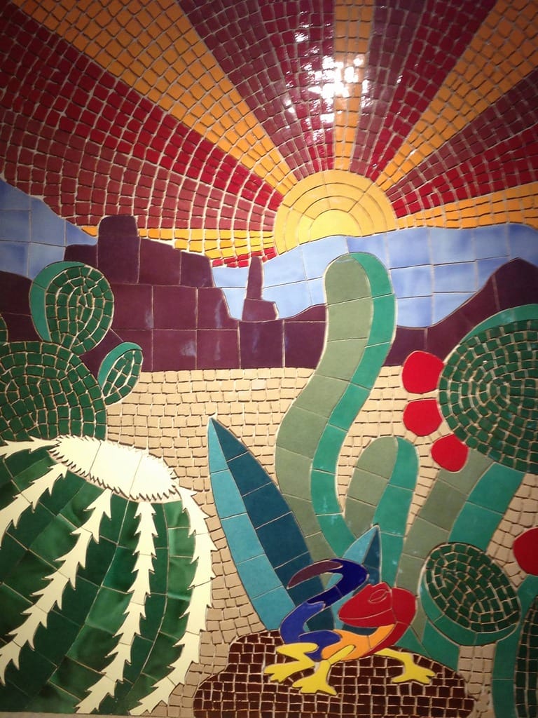 Colorful desert mosaic with sun and cacti