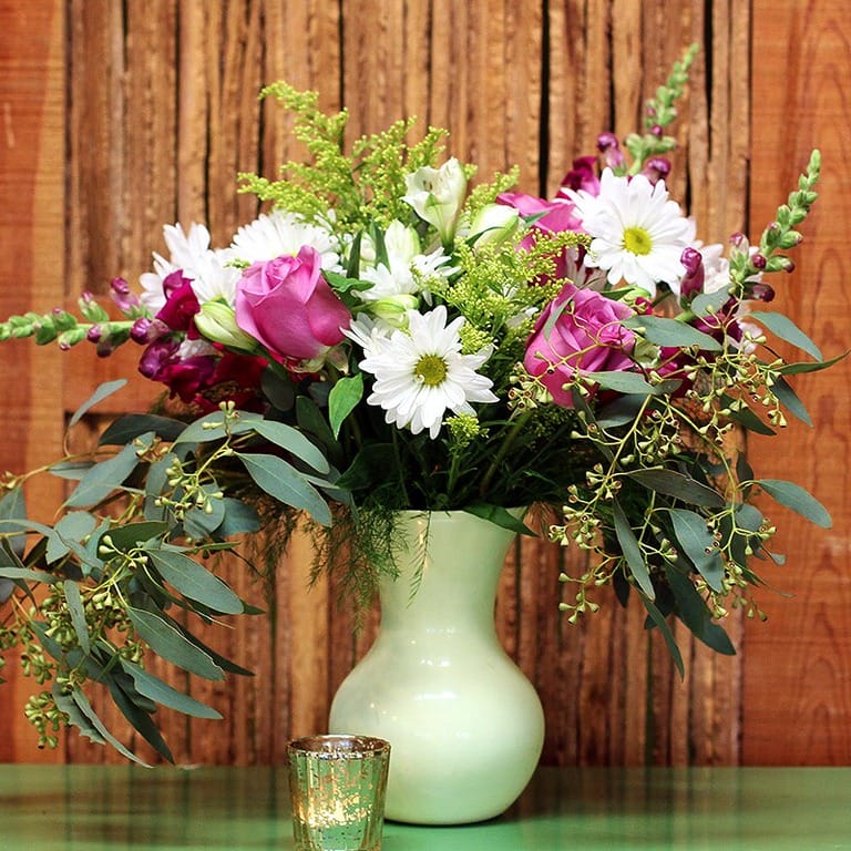 Colorful bouquet in light green vase