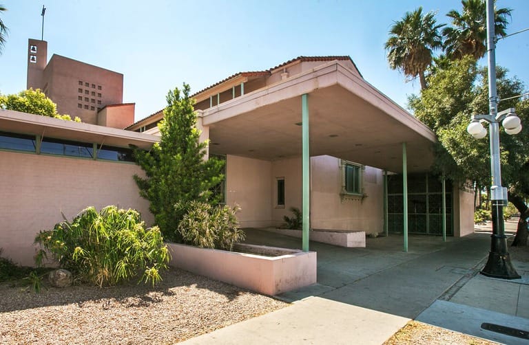 Modern building with lush greenery and street lamp