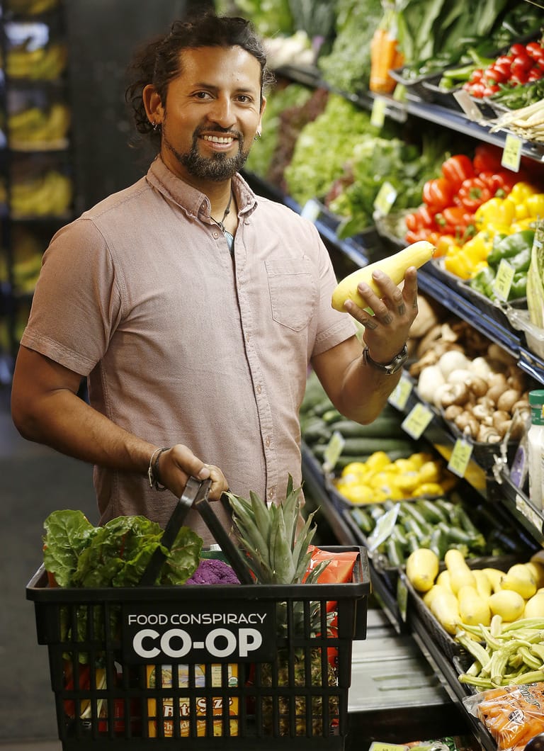 Man shopping for fresh vegetables in a co-op