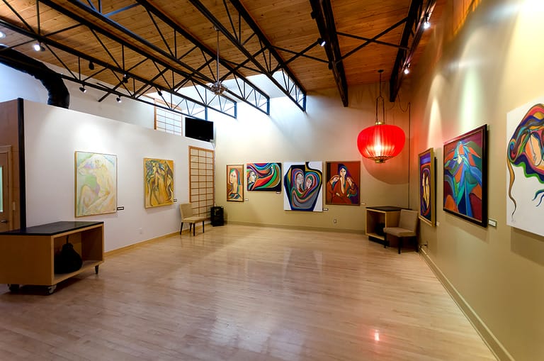 Contemporary art gallery with colorful paintings