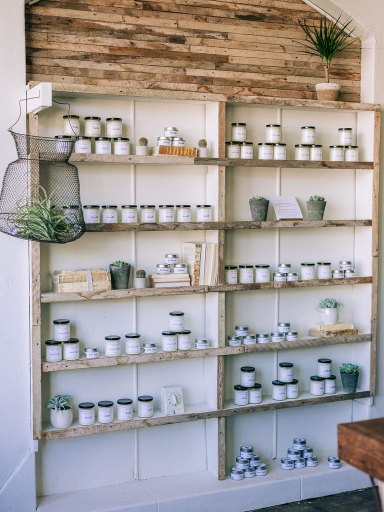 Wooden shelves with jars and plants