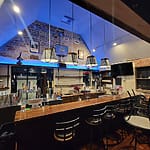 Cozy bar interior with modern lighting.