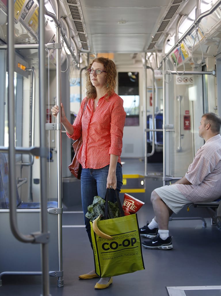 Woman with grocery bag on public transit