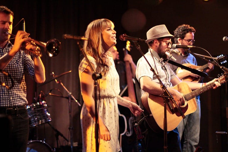 Band performing on stage with instruments