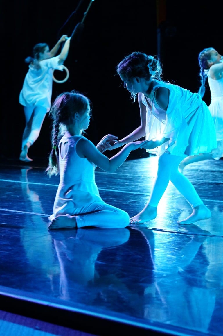 Children performing a dance on stage