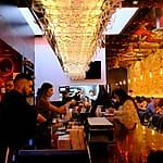 Bar with hanging glasses and patrons